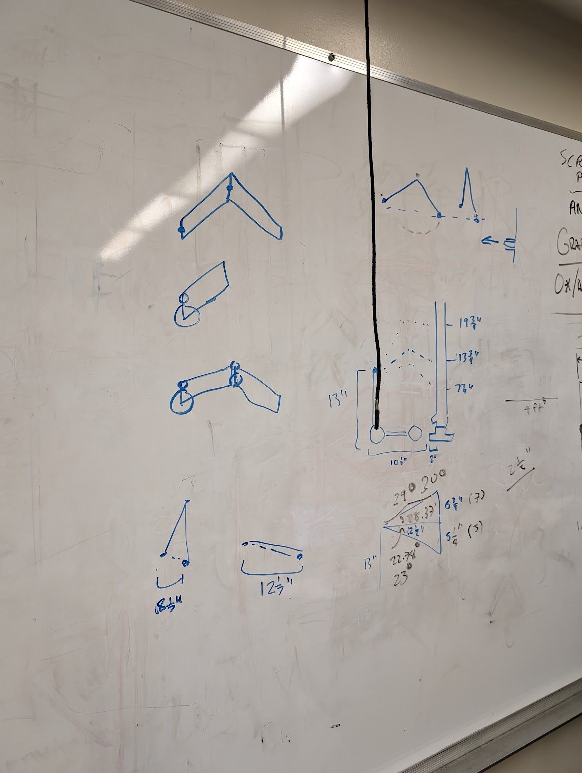 A whiteboard showing some of our planning for reaching the dowels on the trees.
